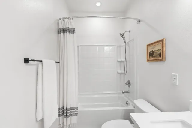 a bathroom with a bathtub and a shower