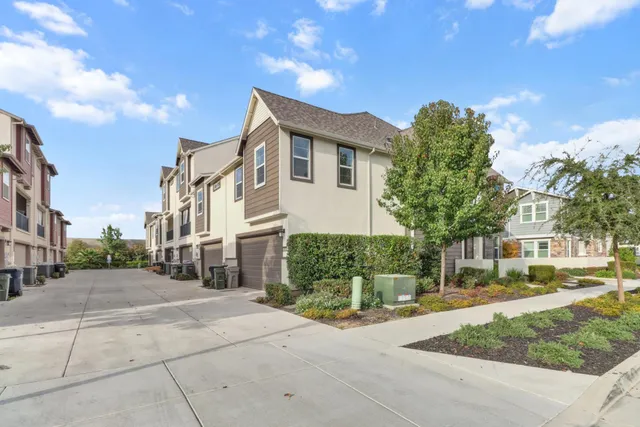 a front view of a house with a yard and trees