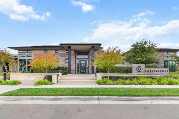 a front view of a house with a garden and pathway