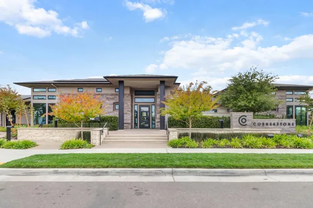 a front view of a house with a garden and pathway