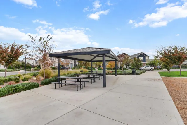 a view of a patio with a table and chairs under an umbrella