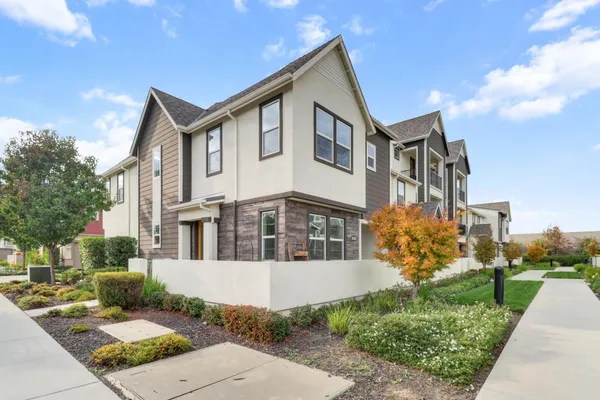 a front view of a house with a garden