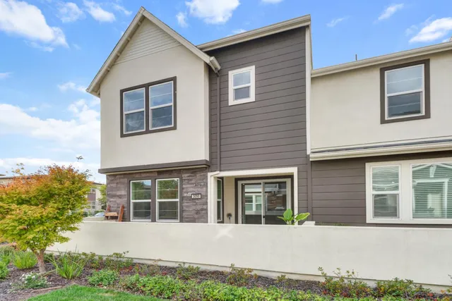 a view of a house with yard and sitting area