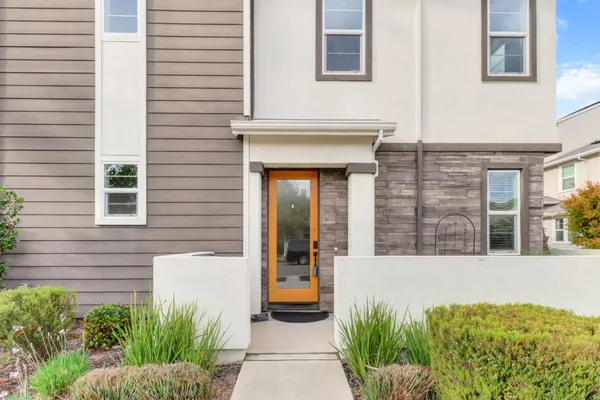 a view of a house with potted plants