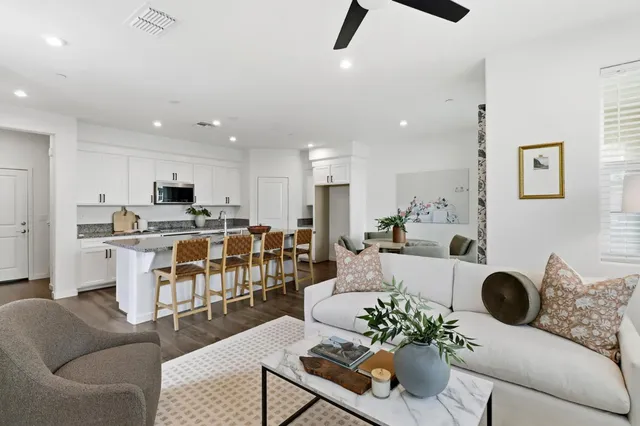 a living room with furniture and kitchen view