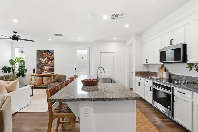 a kitchen with stainless steel appliances granite countertop a sink and cabinets