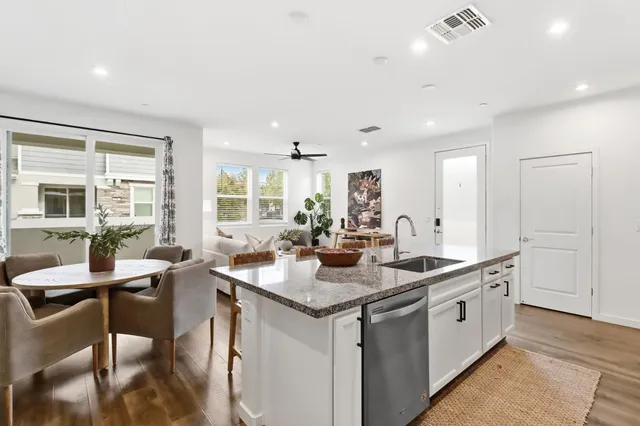 a kitchen with sink and view living room