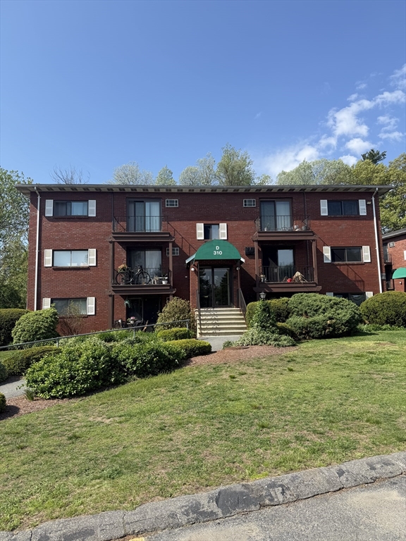 310 Codman Hill Road, Unit 34D Boxborough, MA 01719 - Photo 1 of 17 a front view of a house with a yard