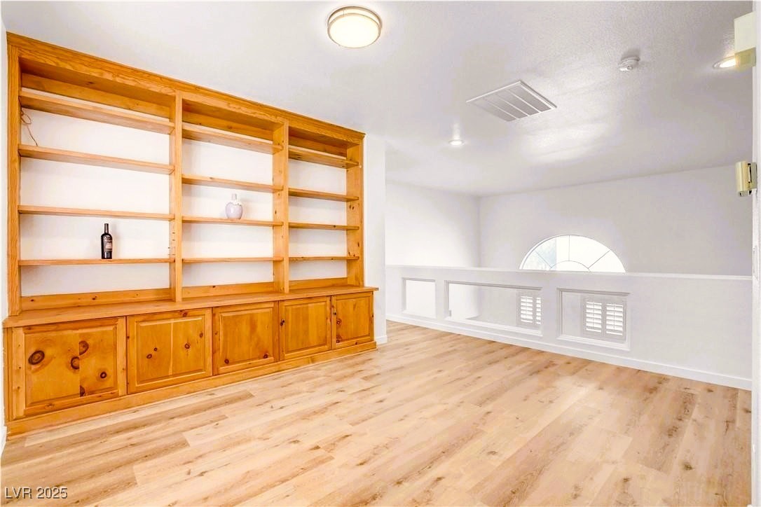 10247 Splendor Ridge Avenue Las Vegas, NV 89135 - Photo 15 of 38 Empty room featuring light wood-style floors