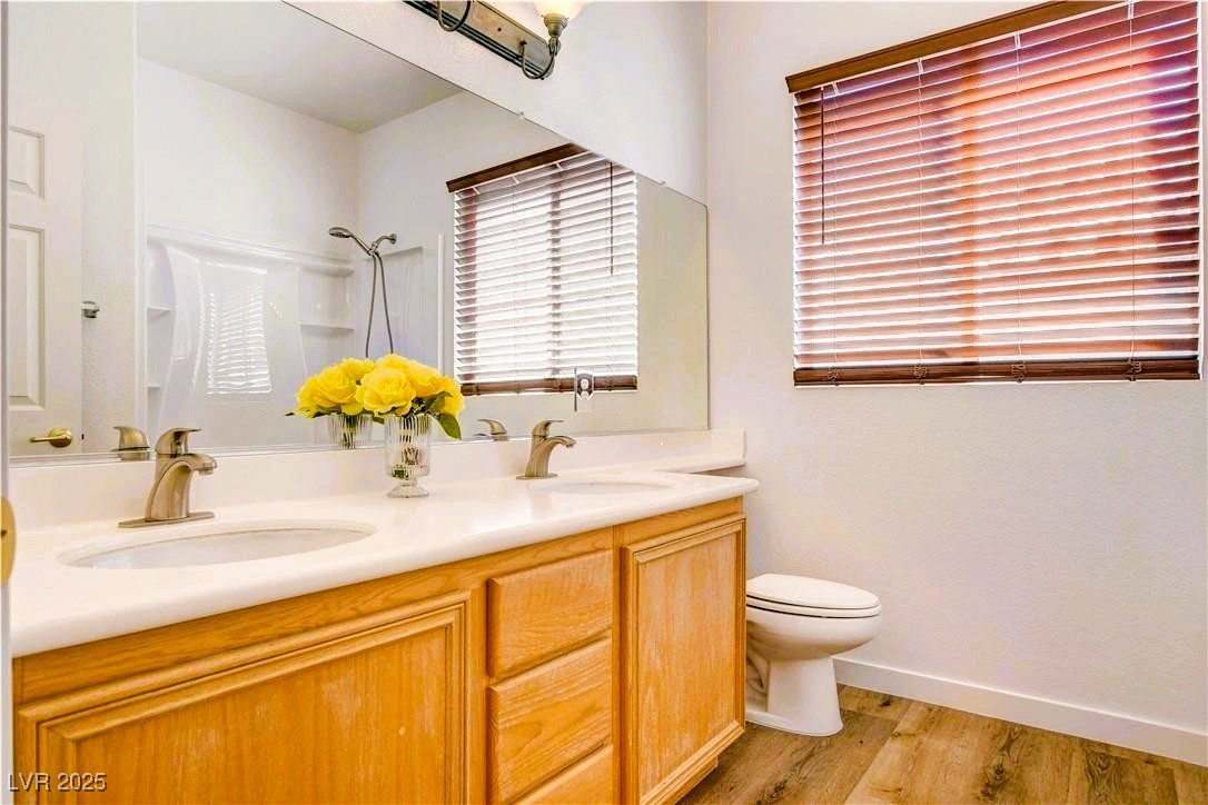 10247 Splendor Ridge Avenue Las Vegas, NV 89135 - Photo 17 of 38 Bathroom featuring light wood-type flooring and double vanity