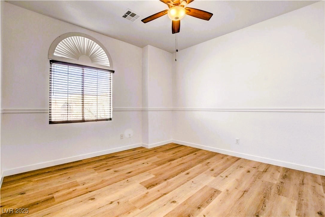 10247 Splendor Ridge Avenue Las Vegas, NV 89135 - Photo 19 of 38 Spare room with light wood-style flooring and ceiling fan