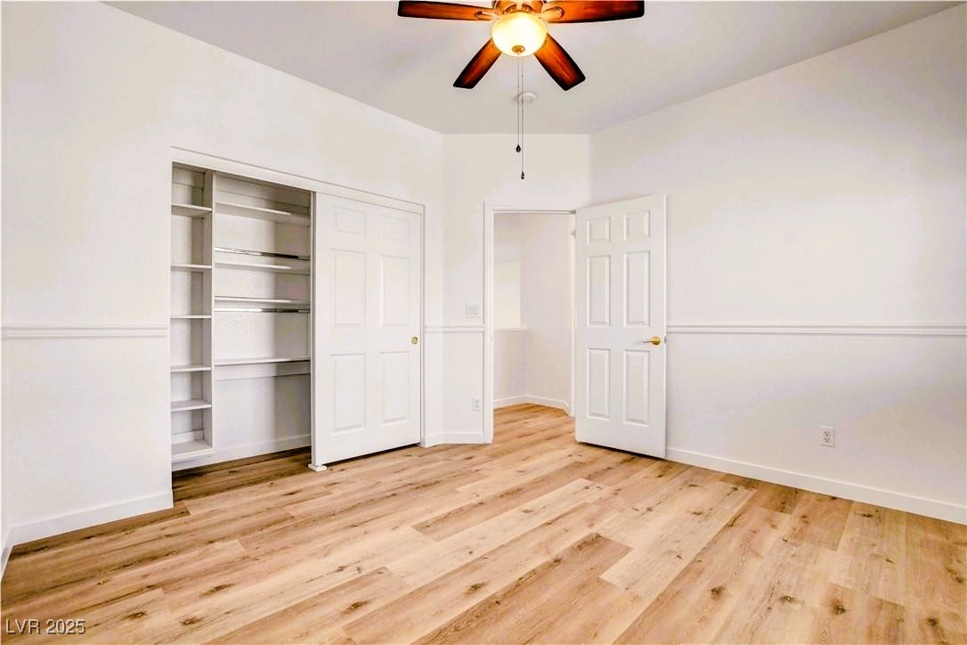10247 Splendor Ridge Avenue Las Vegas, NV 89135 - Photo 20 of 38 Unfurnished bedroom with light wood-style floors, a closet, and a ceiling fan