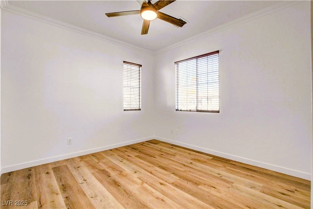 10247 Splendor Ridge Avenue Las Vegas, NV 89135 - Photo 21 of 38 Unfurnished room with crown molding, light wood-type flooring, and ceiling fan