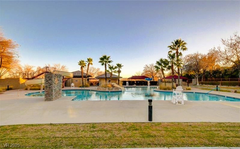 10247 Splendor Ridge Avenue Las Vegas, NV 89135 - Photo 22 of 38 Pool at dusk featuring a patio and a community pool