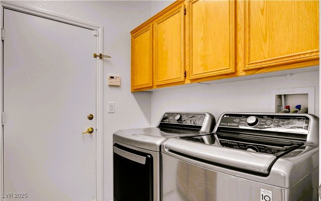 10247 Splendor Ridge Avenue Las Vegas, NV 89135 - Photo 31 of 38 Washroom featuring cabinet space and washing machine and clothes dryer