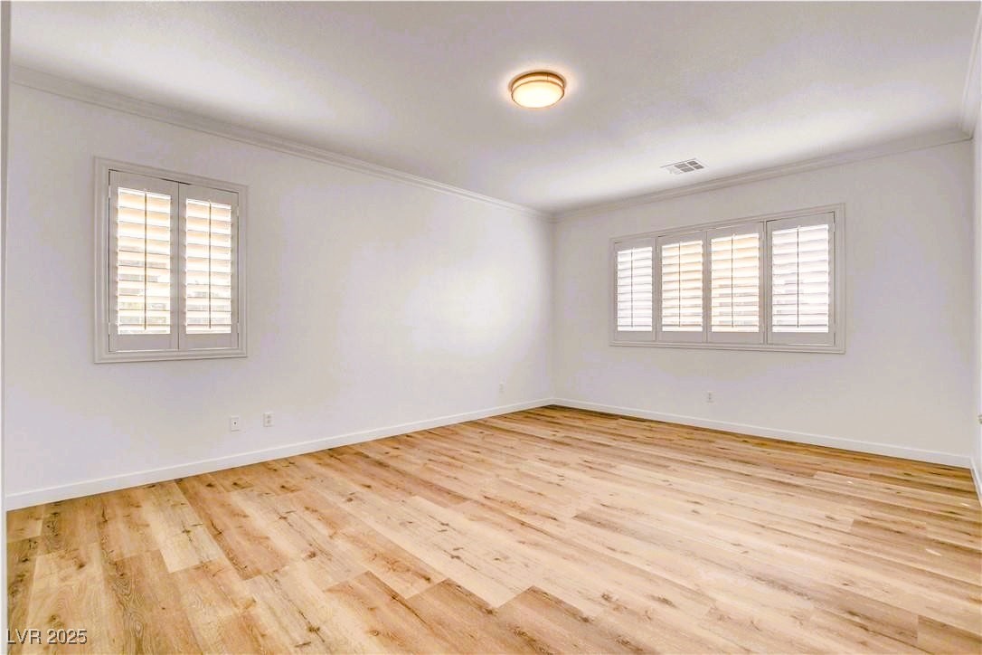 10247 Splendor Ridge Avenue Las Vegas, NV 89135 - Photo 8 of 38 Unfurnished room with ornamental molding and light wood-style floors