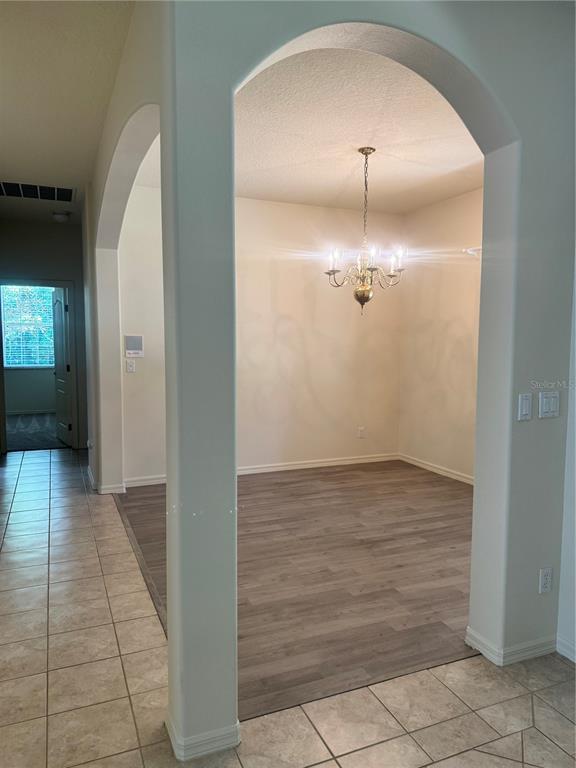 11145 Northwest 17th Court Road Ocala, FL 34475 - Photo 29 of 59 en empty room with wooden floor and mirror