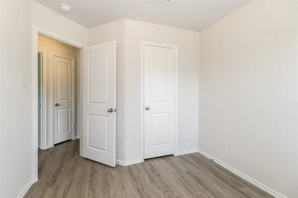 a view of a room with wooden floor