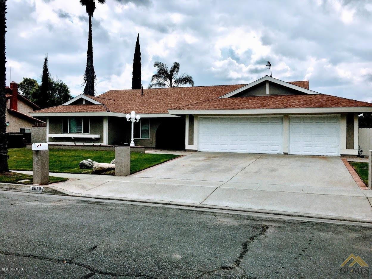 2050 North Riverside Avenue Rialto, CA 92377 - Photo 1 of 18 a front view of house with yard
