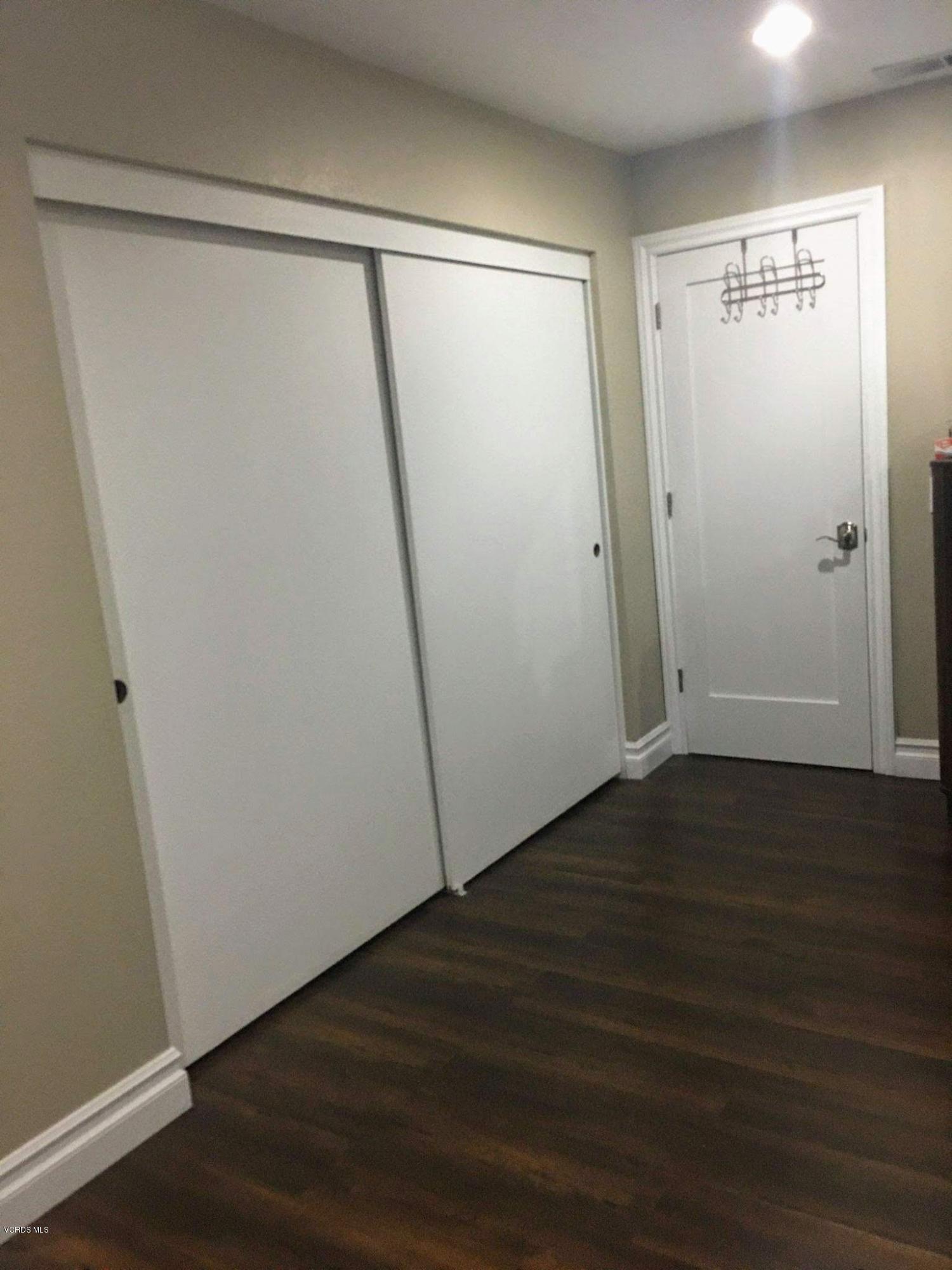 2050 North Riverside Avenue Rialto, CA 92377 - Photo 13 of 18 an empty room with wooden floor and entrance