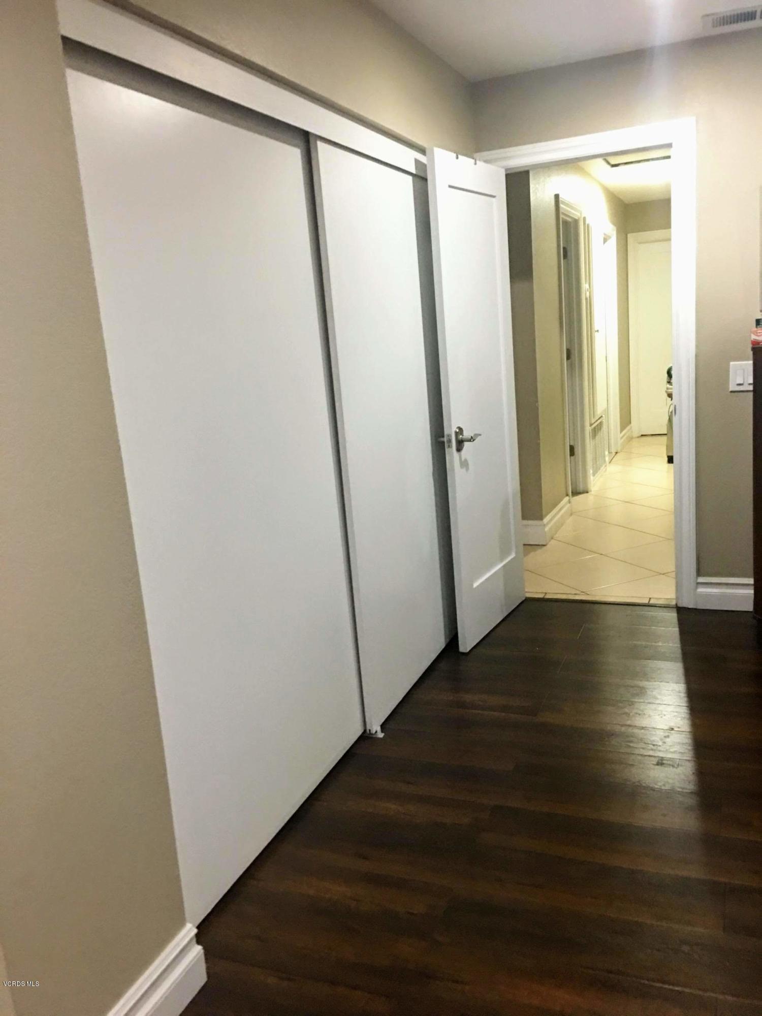 2050 North Riverside Avenue Rialto, CA 92377 - Photo 14 of 18 a view of hallway with wooden floor