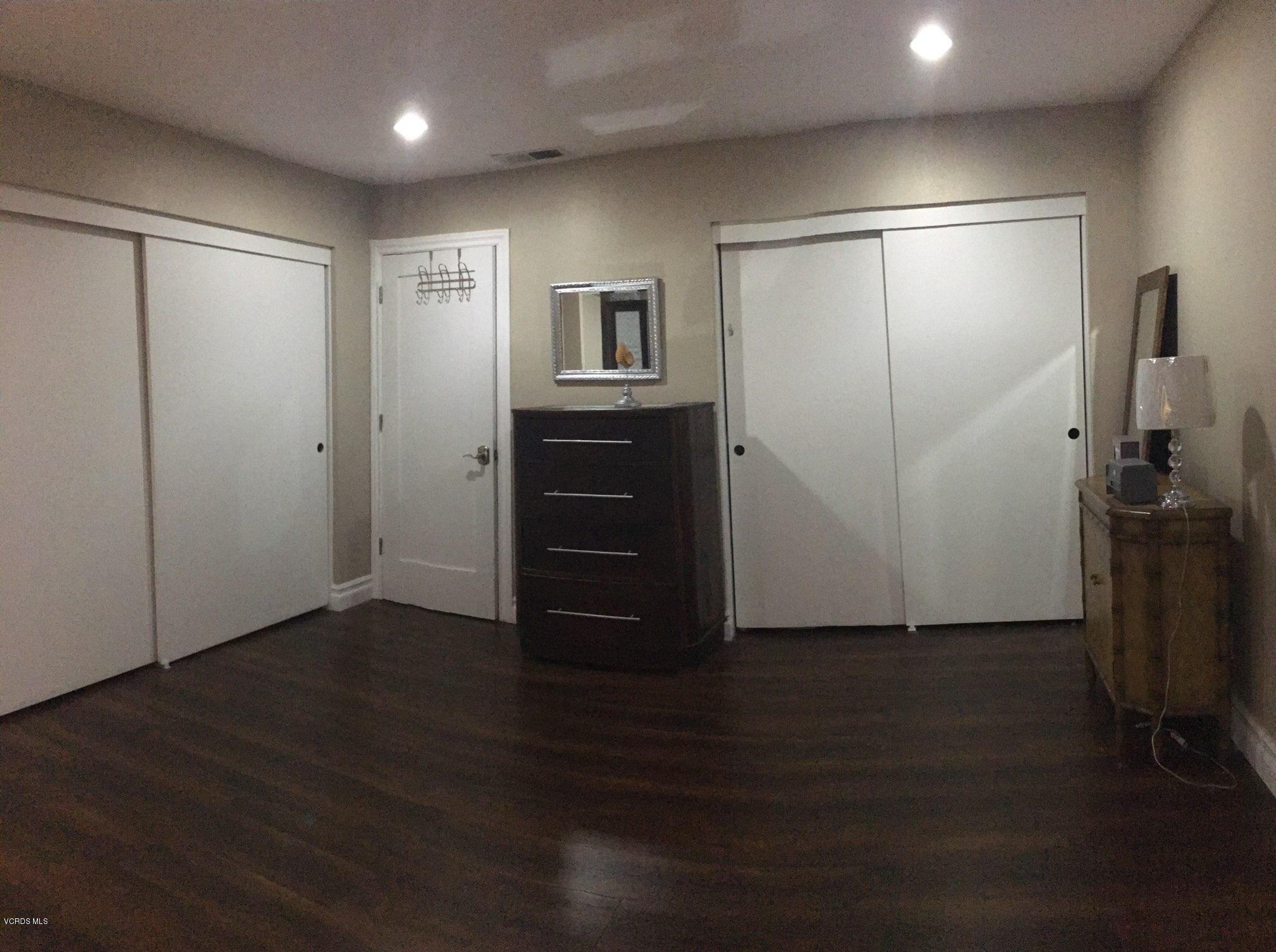 2050 North Riverside Avenue Rialto, CA 92377 - Photo 15 of 18 a view of an empty room with wooden floor and a cabinet