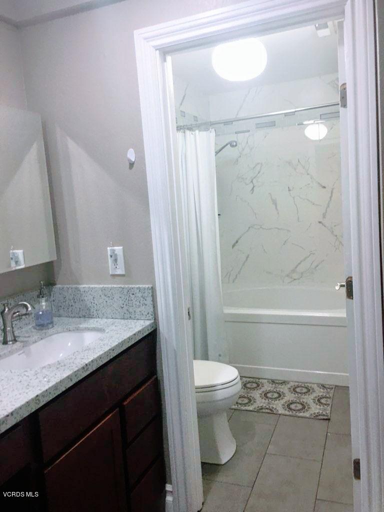 2050 North Riverside Avenue Rialto, CA 92377 - Photo 17 of 18 a bathroom with a granite countertop sink toilet and shower