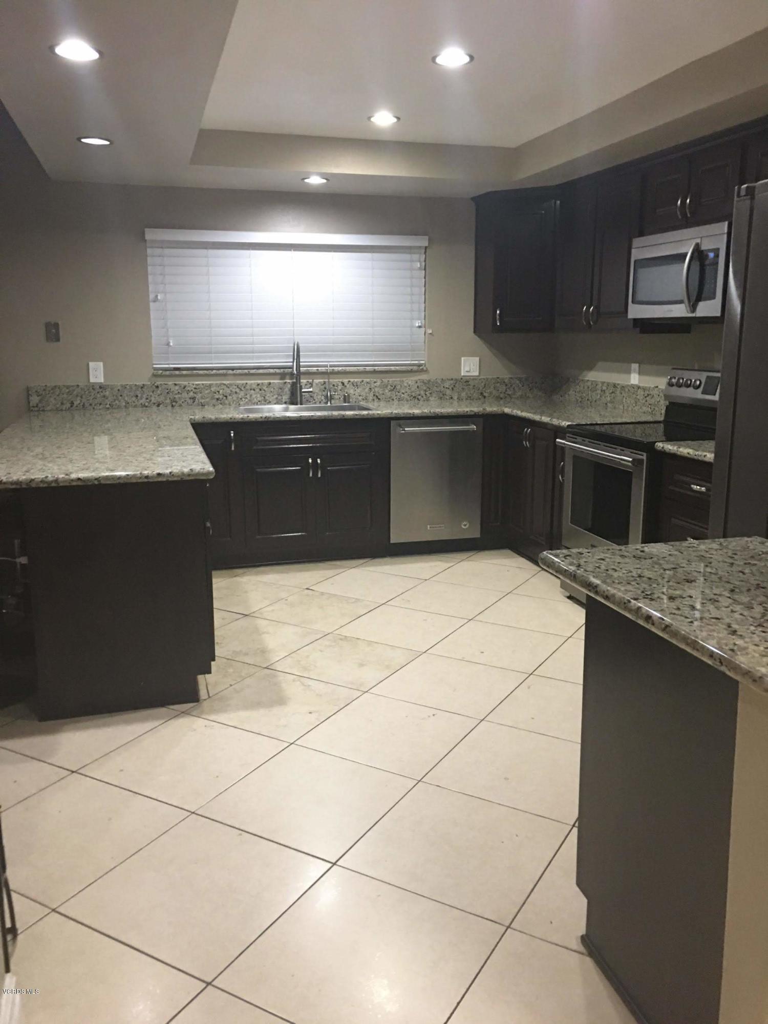 2050 North Riverside Avenue Rialto, CA 92377 - Photo 3 of 18 a kitchen with stainless steel appliances granite countertop a sink and a stove