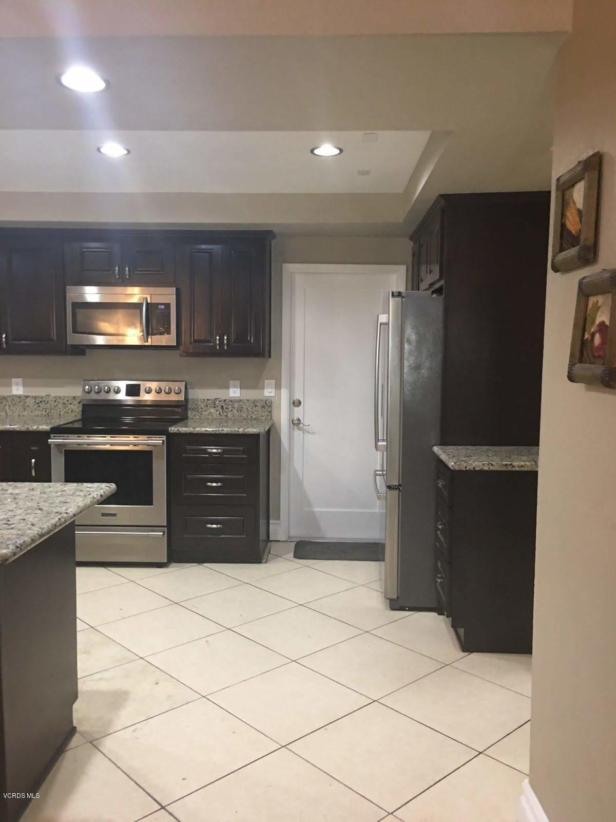 2050 North Riverside Avenue Rialto, CA 92377 - Photo 4 of 18 a kitchen with stainless steel appliances granite countertop a refrigerator and a stove top oven