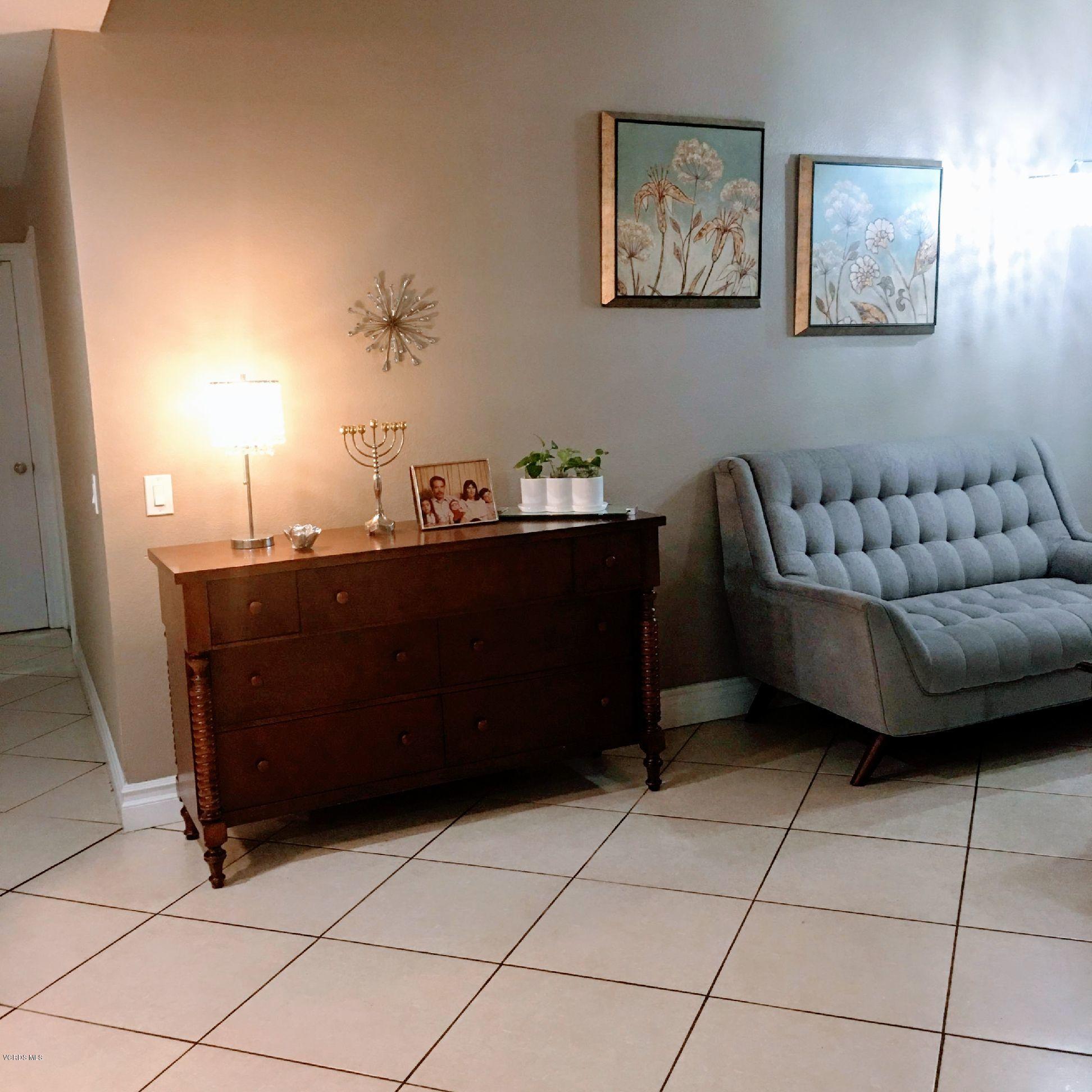 2050 North Riverside Avenue Rialto, CA 92377 - Photo 10 of 18 a living room with a couch and a table