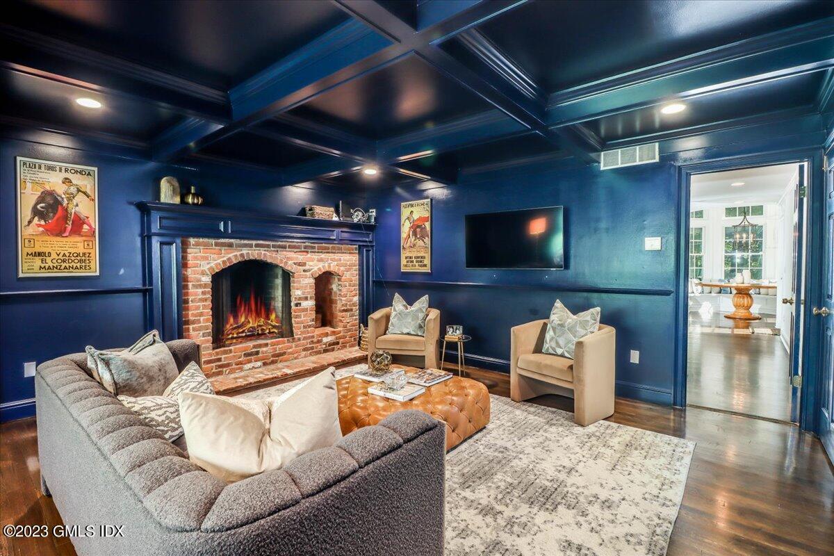 62 North Old Stone Bridge Road Cos Cob, CT 06807 - Photo 10 of 32 a living room with furniture a fireplace and a flat screen tv