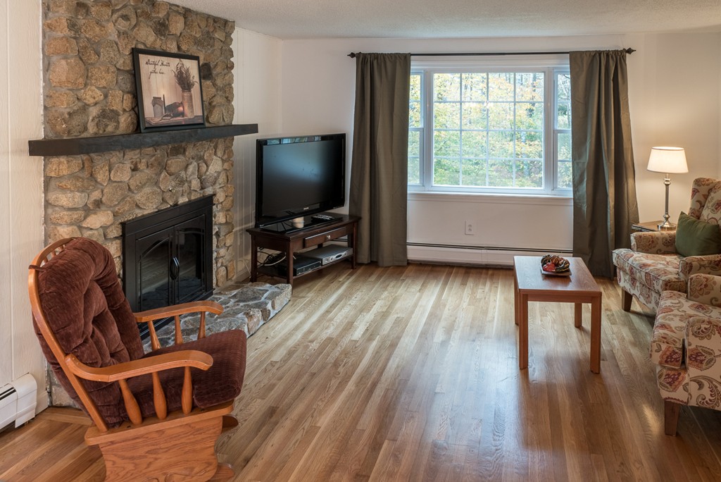 20 Bay Road Easton, MA 02356 - Photo 2 of 7 a living room with furniture a flat screen tv and a fireplace