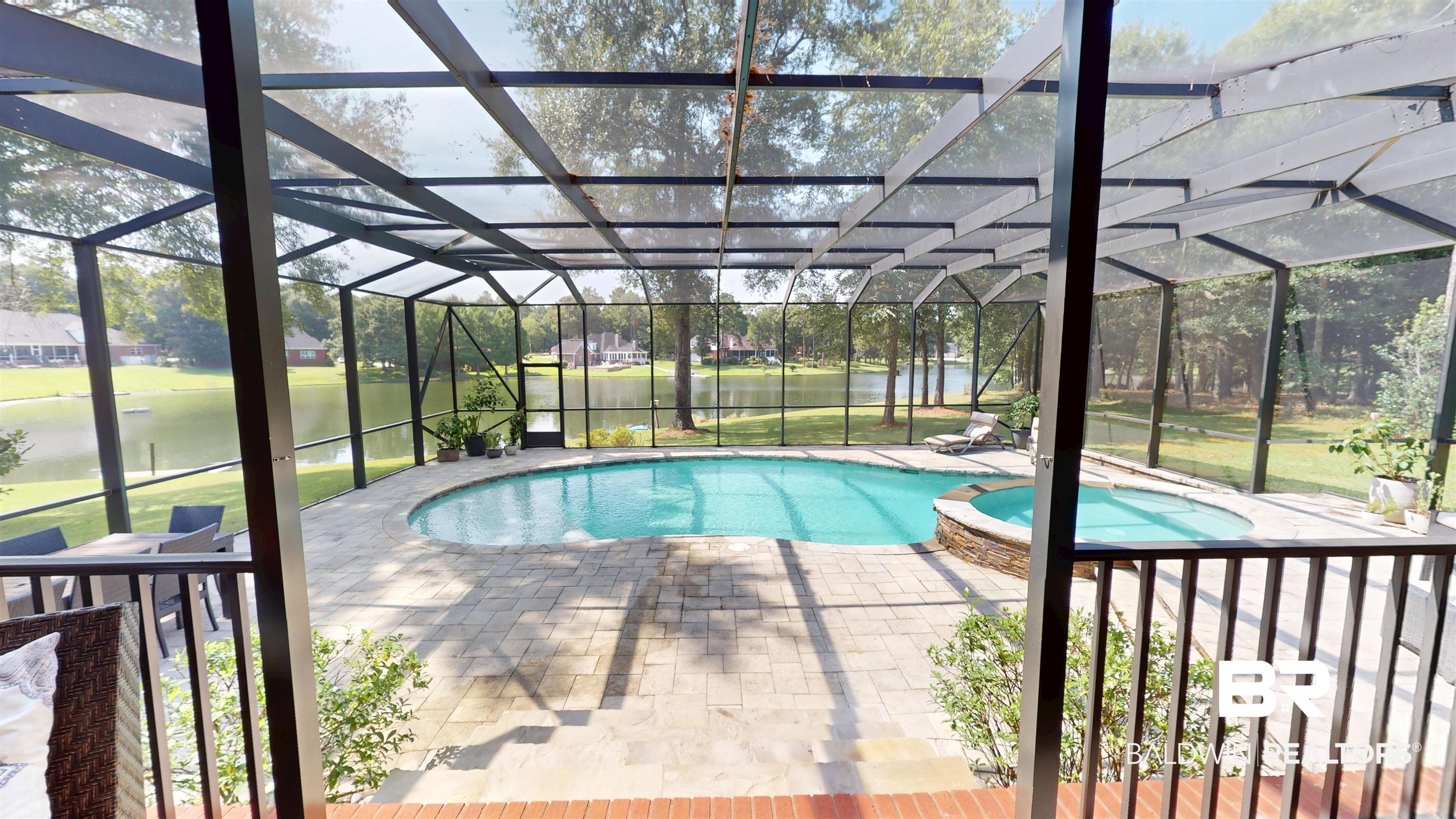 8775 Dawes Lake Road North Mobile, AL 36619 - Photo 44 of 59 View of swimming pool featuring a water view, a pool with connected hot tub, a lanai, and a patio area