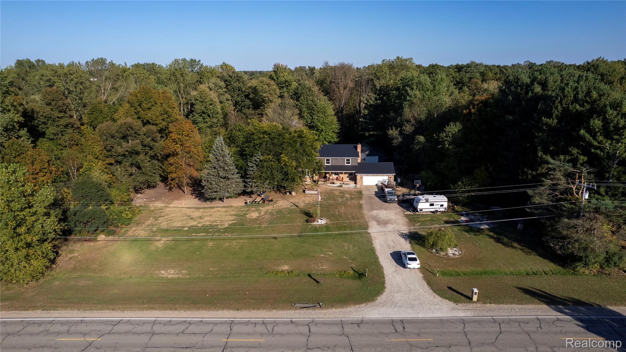 10147 South Bray Road Clio, MI 48420 - Photo 49 of 57 Aerial view of property and surrounding area featuring a forest