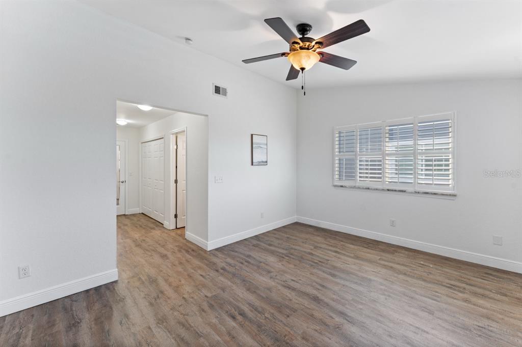 802 Hidden Harbour Drive Indian Rocks Beach, FL 33785 - Photo 16 of 31 a view of an empty room with window and wooden floor