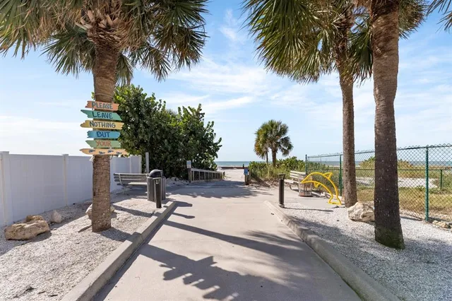 a kitchen with granite countertop a refrigerator and a sink