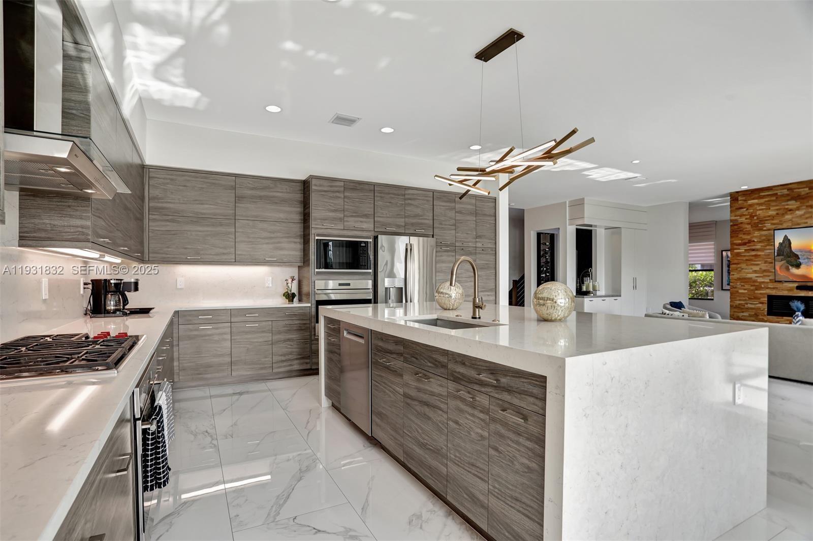 17113 Aquavera Way Boca Raton, FL 33496 - Photo 25 of 84 a kitchen with stainless steel appliances kitchen island granite countertop a stove and a sink