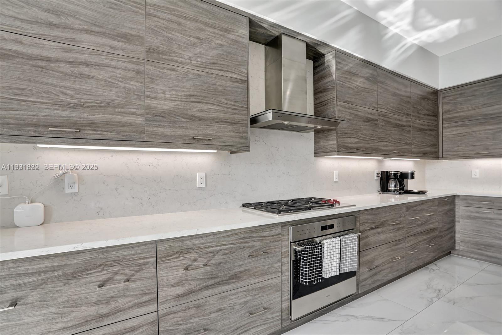 17113 Aquavera Way Boca Raton, FL 33496 - Photo 26 of 84 a kitchen with stainless steel appliances granite countertop a stove and a sink