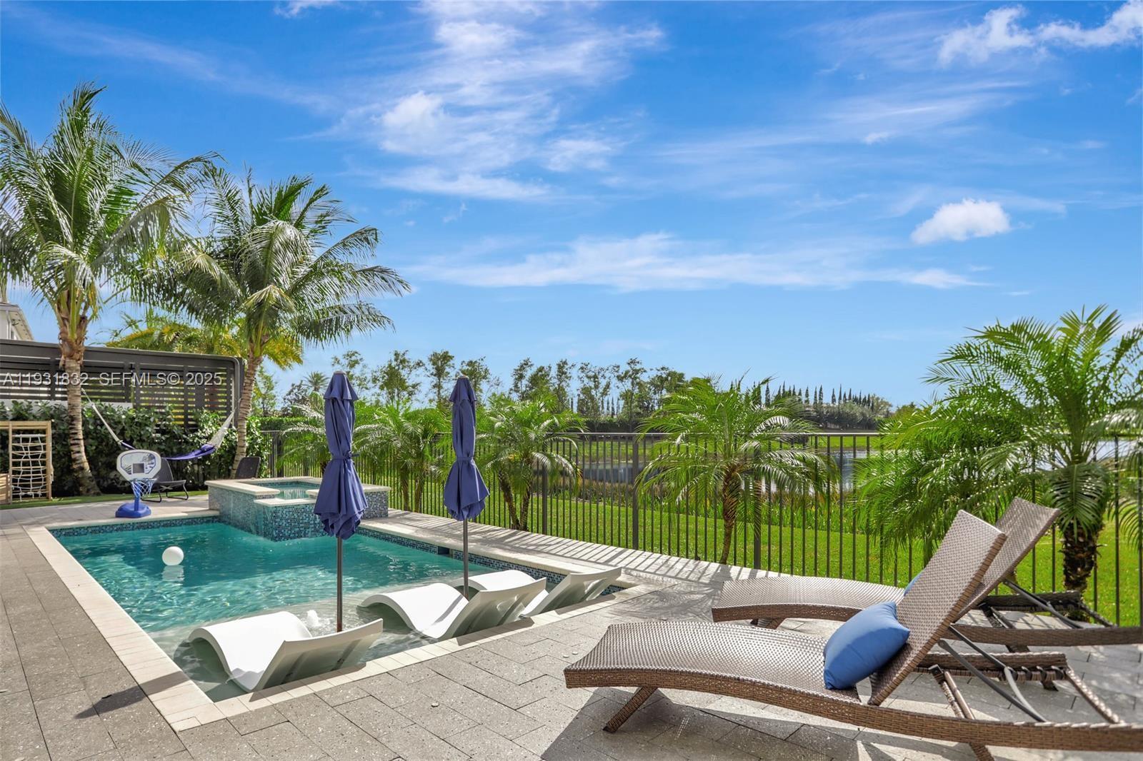 17113 Aquavera Way Boca Raton, FL 33496 - Photo 36 of 84 a view of a patio with swimming pool and sitting area