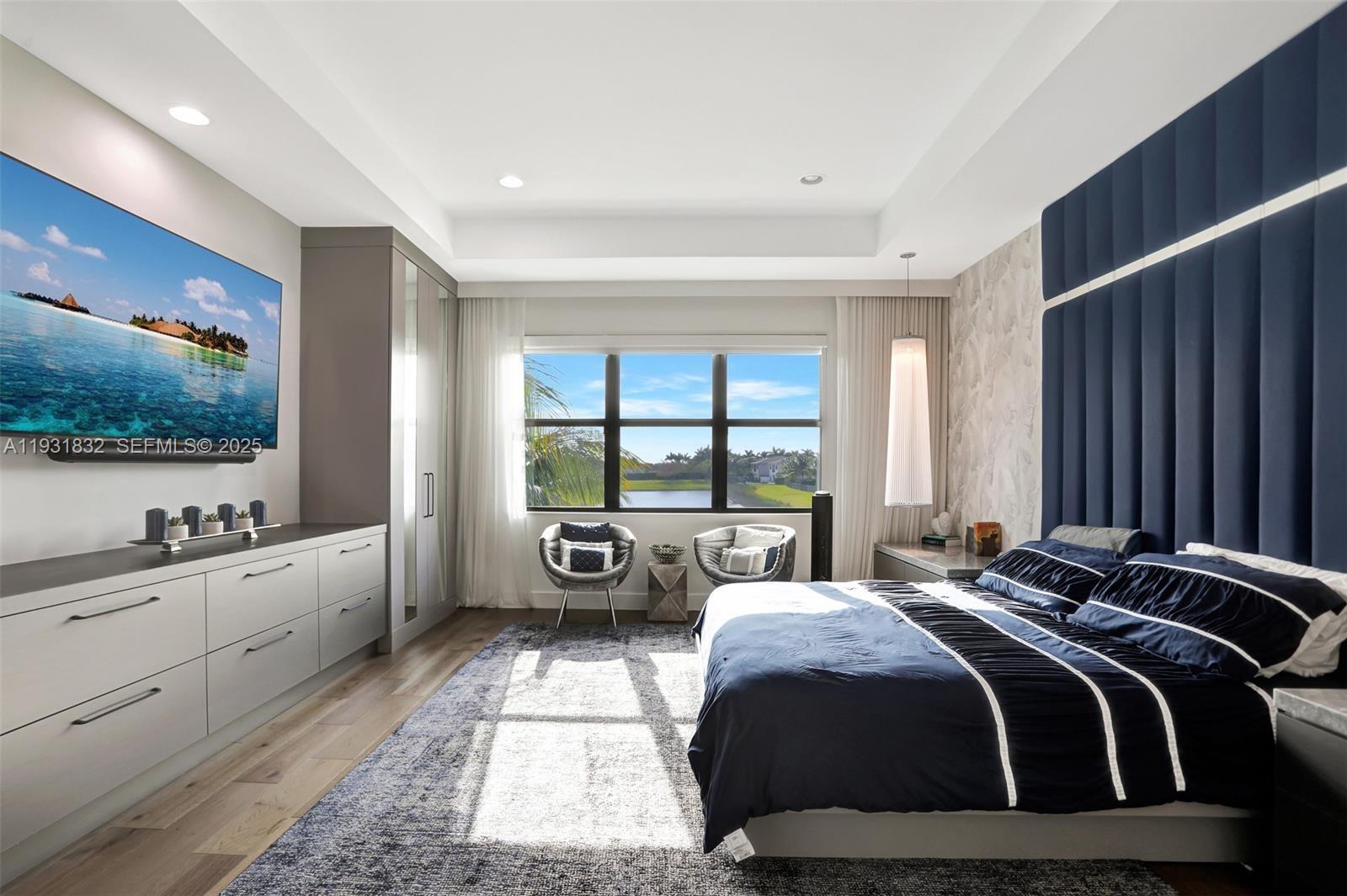 17113 Aquavera Way Boca Raton, FL 33496 - Photo 40 of 84 a large bedroom with a large bed and a flat tv screen on dresser