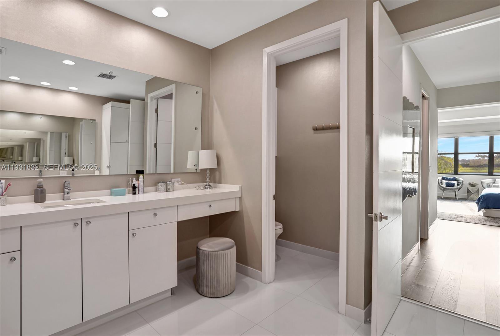 17113 Aquavera Way Boca Raton, FL 33496 - Photo 45 of 84 a bathroom with a double vanity sink a mirror and a shower