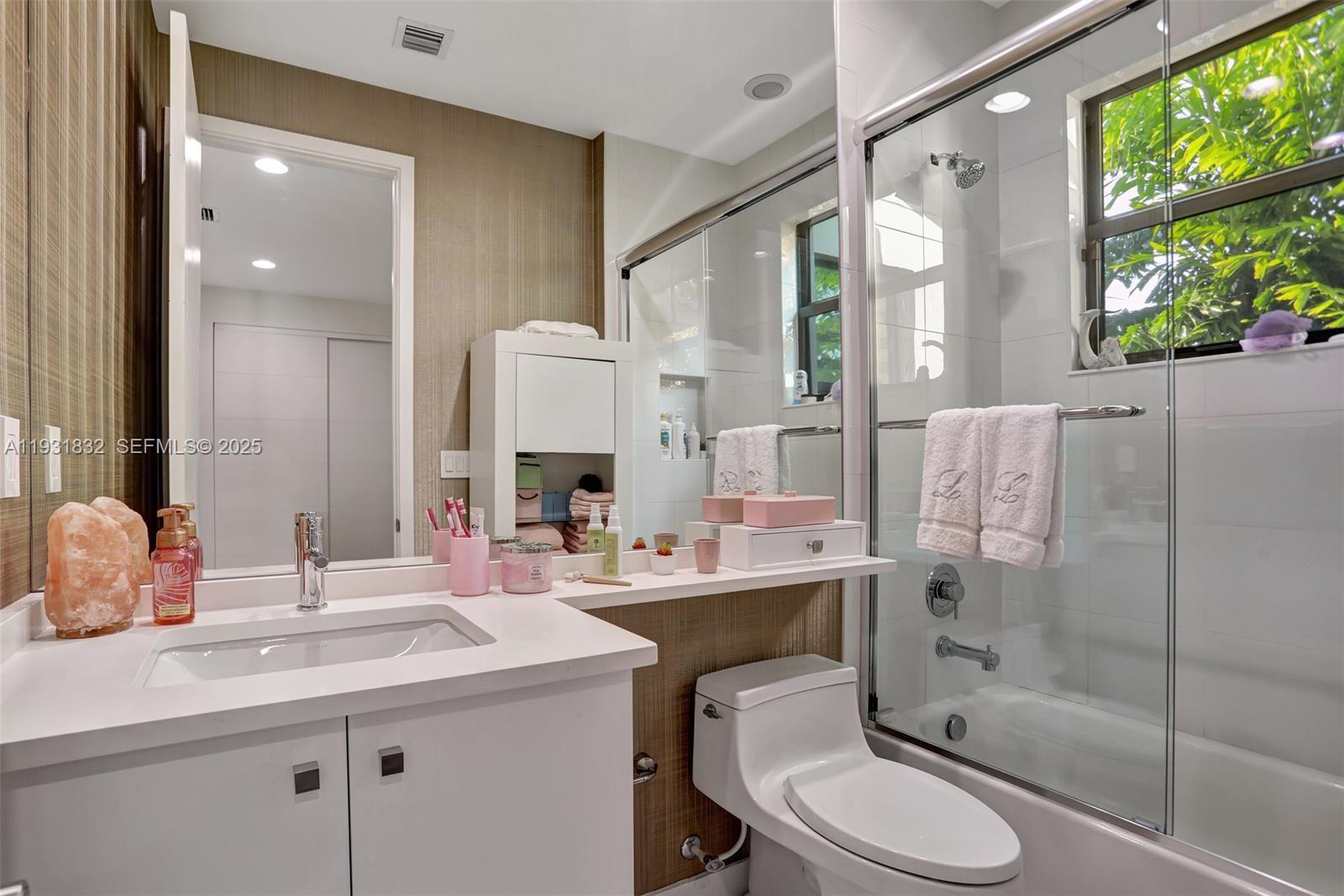 17113 Aquavera Way Boca Raton, FL 33496 - Photo 48 of 84 a bathroom with a sink toilet a mirror and shower