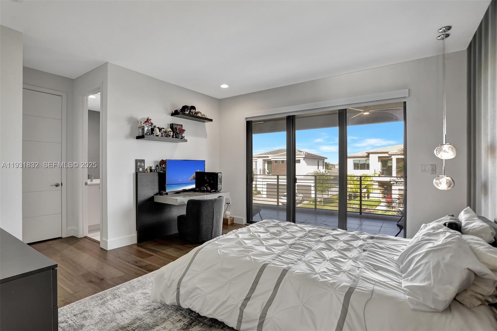 17113 Aquavera Way Boca Raton, FL 33496 - Photo 49 of 84 a bedroom with a bed and a large window