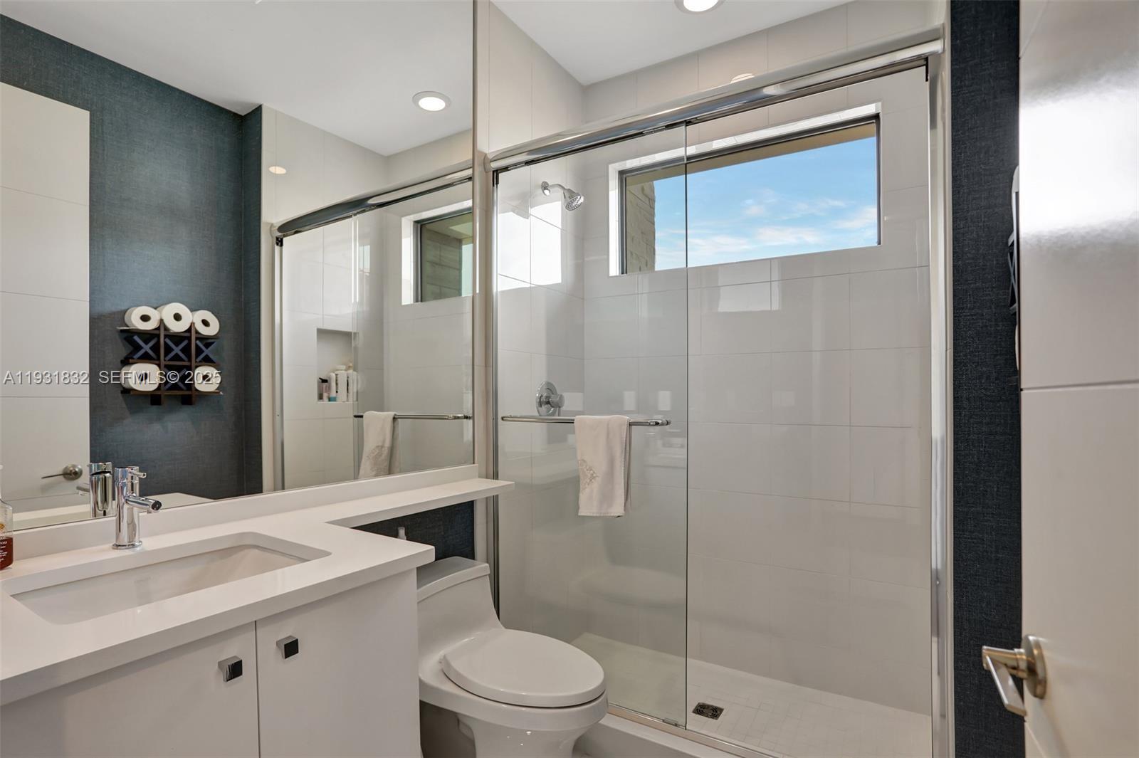 17113 Aquavera Way Boca Raton, FL 33496 - Photo 50 of 84 a bathroom with a sink toilet and shower