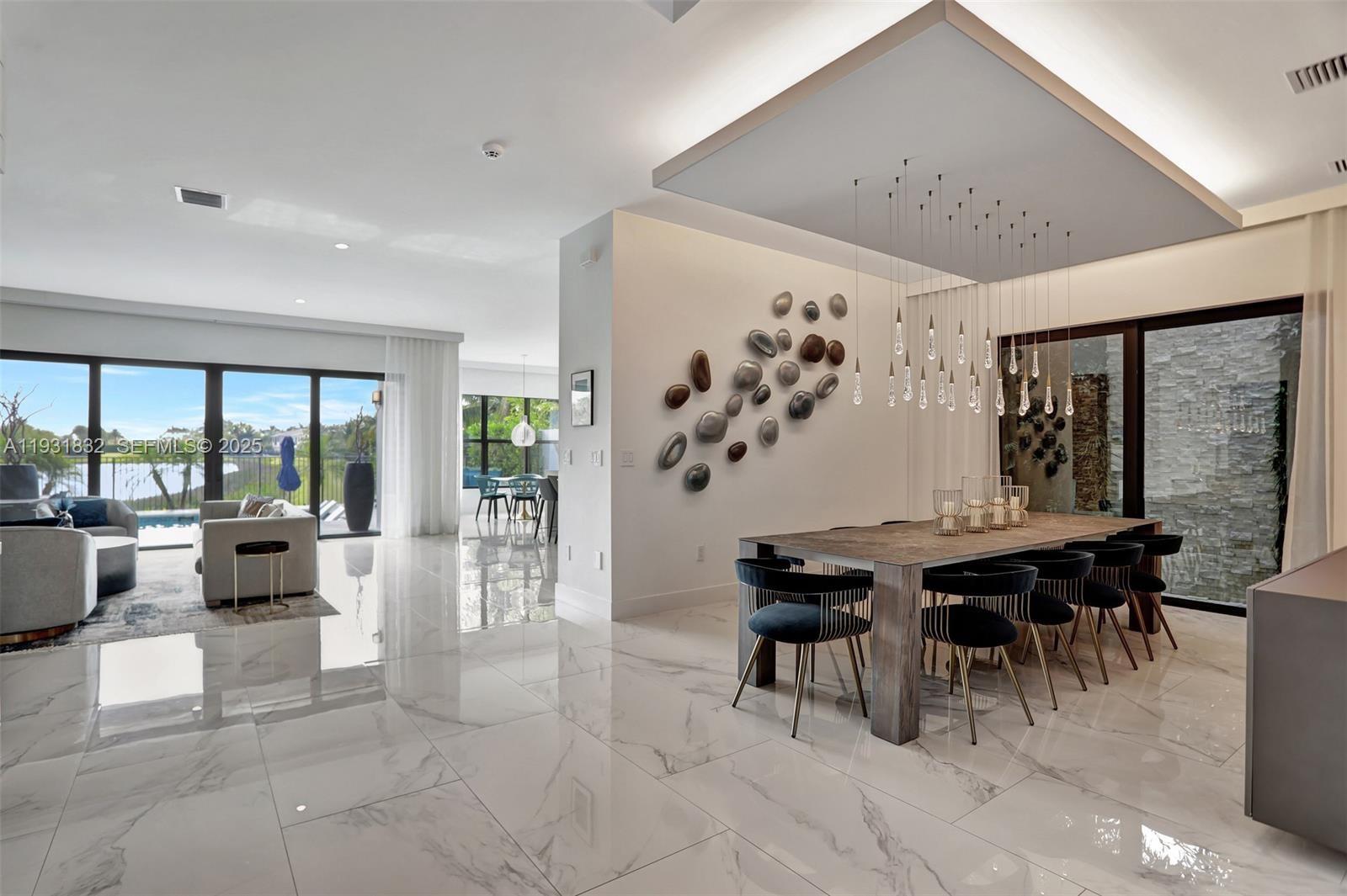17113 Aquavera Way Boca Raton, FL 33496 - Photo 7 of 84 a view of a dining room with furniture window and wooden floor