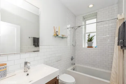 a bathroom with a bathtub shower sink and toilet