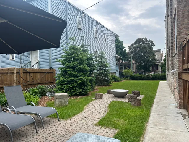a view of a patio with couches chairs and a yard