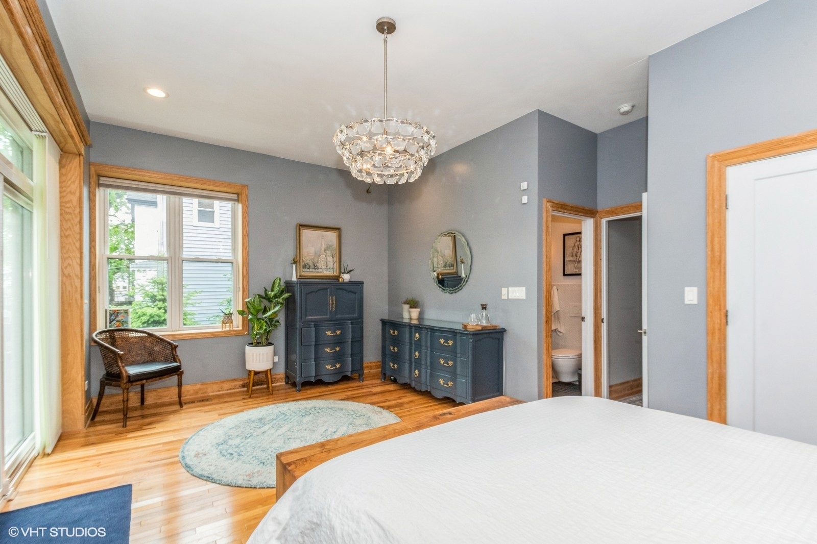 3428 West Belden Avenue, Unit 1 Chicago, IL 60647 - Photo 9 of 19 a spacious bedroom with a bed and a chandelier