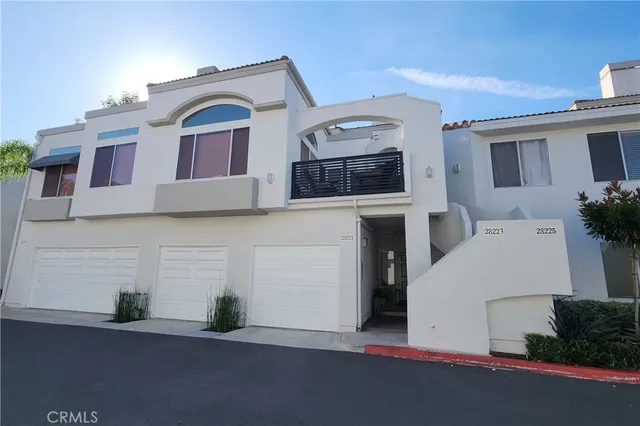 a view of a hallway with wooden floor and a bathroom