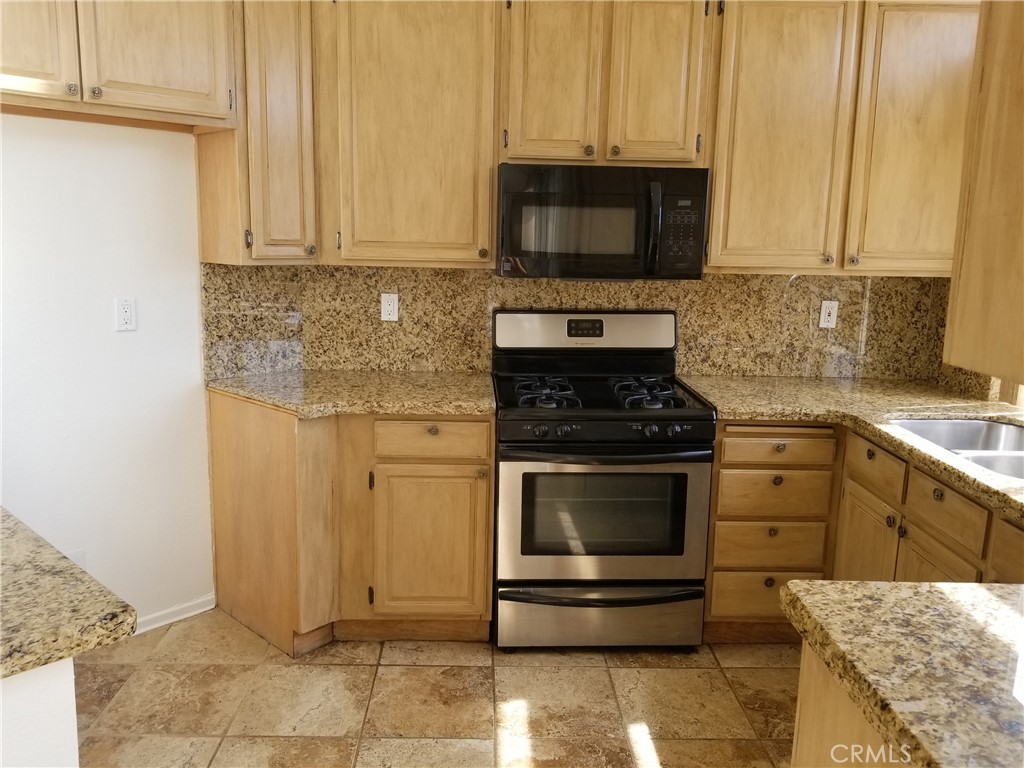 28225 Via Fierro Laguna Niguel, CA 92677 - Photo 14 of 70 a kitchen with appliances a sink and cabinets